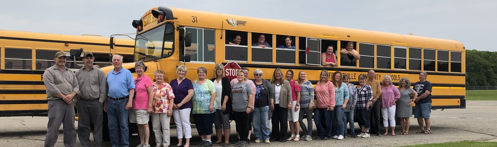 FCS Transportation Staff photo in front of bus.